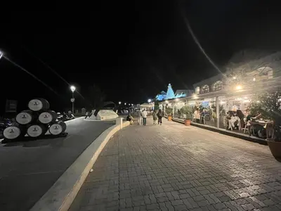 a street at night with people walking down the street at Mirador de Sanlucar 6 in Sanlúcar de Barrameda