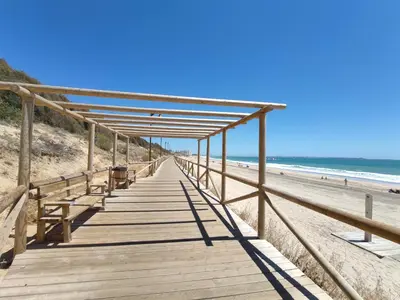 a wooden boardwalk leading down to the beach at Villa Mar de Las Redes in El Puerto de Santa María