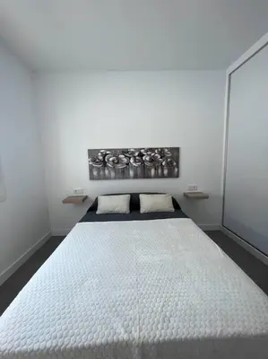 a white bedroom with a large white bed at GRANIZO A in Chiclana de la Frontera