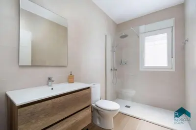 a bathroom with a sink and a toilet and a mirror at Bisonte B in Chiclana de la Frontera