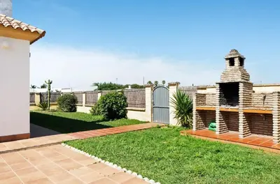 a backyard of a house with a fence at CHALET ROBLES in Cádiz