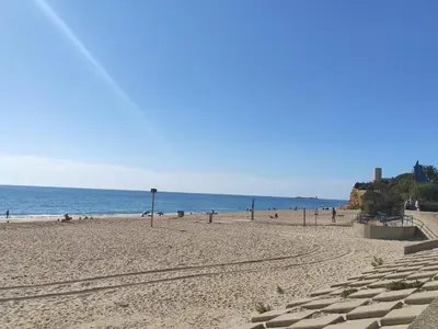 a beach with people and the ocean in the background at Villa El Lagar in Novo Sancti Petri