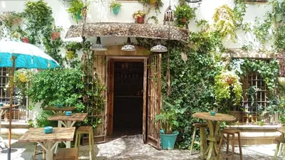 an entrance to a building with tables and chairs at Sherryflat Aina Parking in Jerez de la Frontera