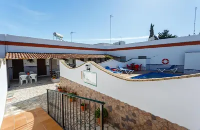 a house with a pool and a large boat at Apartamento Casa Postas II in Conil de la Frontera