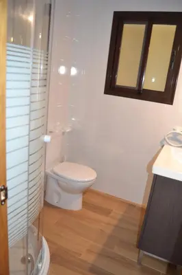 a bathroom with a toilet and a sink and a mirror at CHALET SOLYMAR in Conil de la Frontera