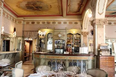 a bar in a restaurant with tables and chairs at Suite del Mercado Little Apartments in Cádiz