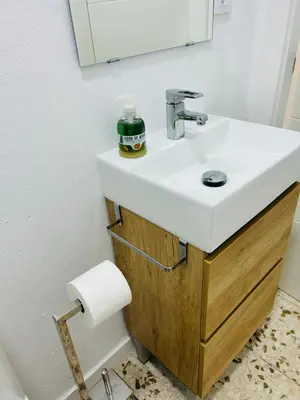 a bathroom with a white sink and a mirror at SOTAVENTO Salmarina in Sanlúcar de Barrameda