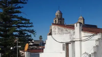 a white building with a clock tower on top of it at PISO CENTRO HISTÓRICO 3 DORMITORIOS in Jerez de la Frontera