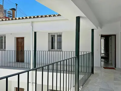 an external view of a white house with black railing at Apartamento El Tabanco - Ole Solutions in Jerez de la Frontera