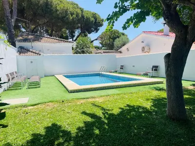 a pool in the backyard of a house at Entre Pinos in Chiclana de la Frontera