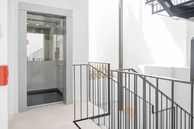 a staircase in a building with a glass door at Sanlucar Centro - Apartamento 4 in Sanlúcar de Barrameda