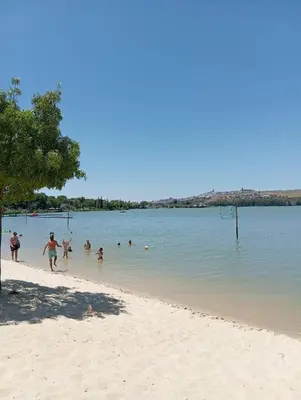 a group of people playing in the water on a beach at Leo's Home in Arcos de la Frontera