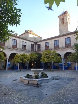 a building with a fountain in the middle of a courtyard at El Patio de María in Bornos