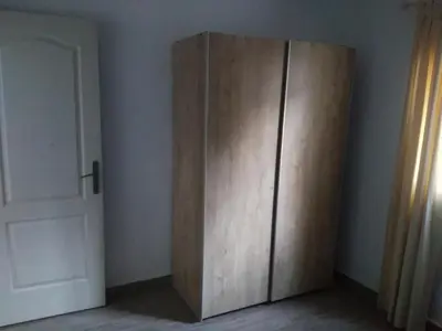 a wooden cabinet in a room next to a door at ALOJAMIENTo RURAL IZAN in Conil de la Frontera