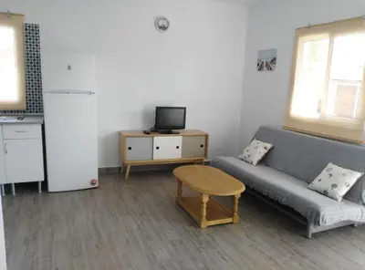 a living room with a couch and a tv at Casa MARINERA in Cádiz