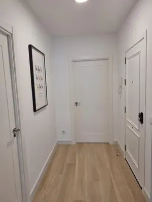 an empty hallway with white walls and wooden floors at Plaza Doctor Barbadillo in Sanlúcar de Barrameda