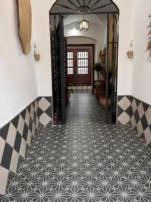 a hallway with a black and white tile floor at El Patio de María 2 in Bornos