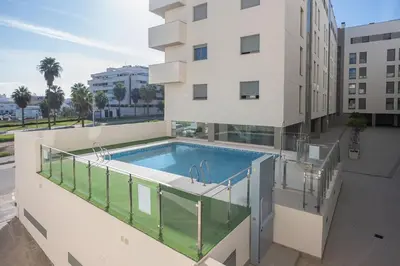 a swimming pool on the balcony of a building at Luminoso Apartamento con Balcón in El Puerto de Santa María