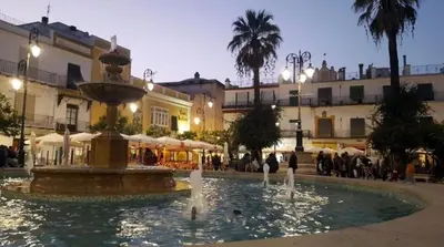 a fountain in the middle of a square with buildings at Mirador Sanlúcar 10 in Sanlúcar de Barrameda