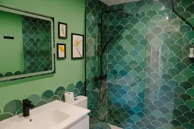 a bathroom with a shower with a sink and a mirror at Apartamento The River in El Puerto de Santa María