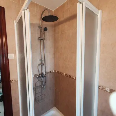 a bathroom with a shower with a tub at Casa Álamo in Puerto Real