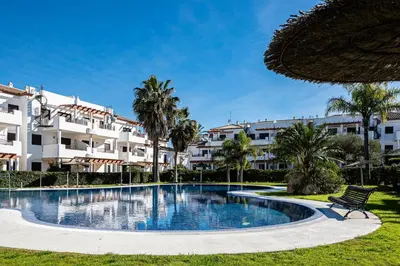 a swimming pool in front of a building at coto 9 16 in Chiclana de la Frontera