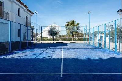 a tennis court in front of a building at coto 4 17 in Chiclana de la Frontera