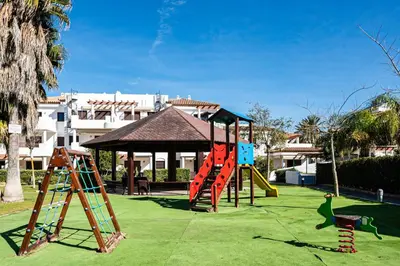 a playground with a slide and a play structure at coto 4 17 in Chiclana de la Frontera