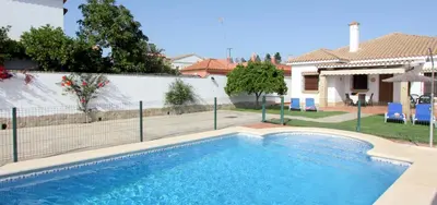 a villa with a swimming pool and a house at Casa Rocio 1 in Conil de la Frontera