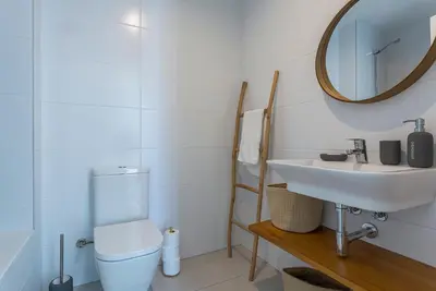 a bathroom with a sink and a toilet and a mirror at Holiday Homes - Ocean Costa Ballena in Cádiz