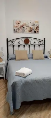 a bedroom with a large bed with two pillows on it at Dúplex a 700 m de la Playa de La Barrosa in Novo Sancti Petri