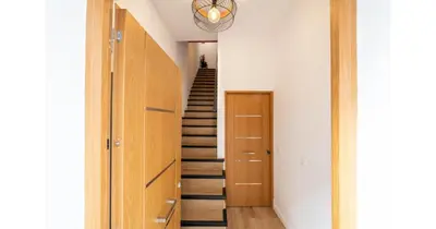 a staircase in a house with a hallway with a stair case at YourHouse Apartamentos Andasol 1 I in Chipiona