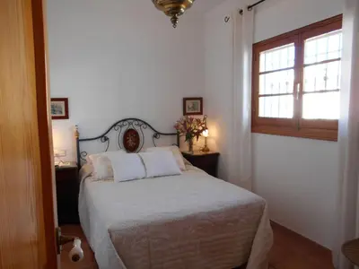 a room with a television and a table and a door at Apartment Penthouse- Klimatisierung- Strand und Sonne das ganze Jahr über by Interhome in Chipiona