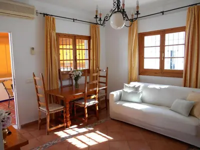 a living room with a white couch and a table at Holiday Home Touristenwohnung Apartment mit Terrasse by Interhome in Chipiona