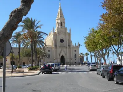 a large church with cars parked in front of it at Apartment Wohnung 'Caracola' mit Terrasse by Interhome in Chipiona
