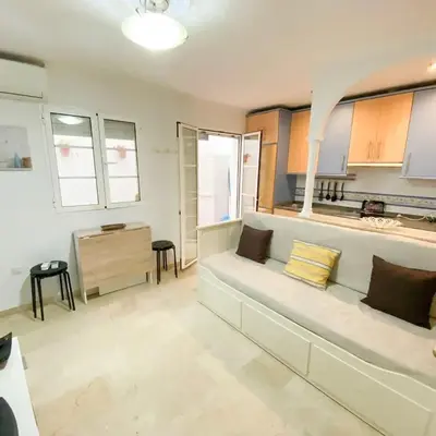 a living room with a couch and a desk at Bulerías de Cádiz by Gades Gestión in Cádiz