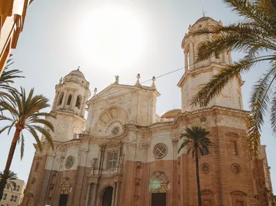 a church with palm trees in front of it at Hidden Gem CADIZ BEACH LOFT by Apartmentsincadiz in Cádiz