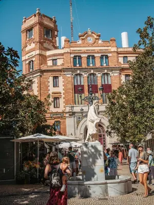 a statue in front of a building with a clock tower at Hidden Gem CADIZ BEACH LOFT by Apartmentsincadiz in Cádiz