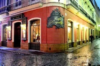 a person walking past a store on a street at Little Arboli Little Apartments in Cádiz