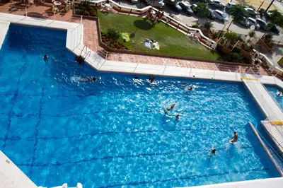 an overhead view of a large swimming pool with people in it at Infantes 8-4-30 in Sanlúcar de Barrameda