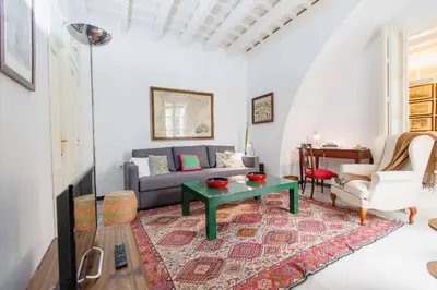 a living room with a couch and a table at Apartamentos La Botanica, Cadiz in Cádiz