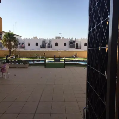 a view of a courtyard with buildings in the background at Playa de Las Piletas in Sanlúcar de Barrameda
