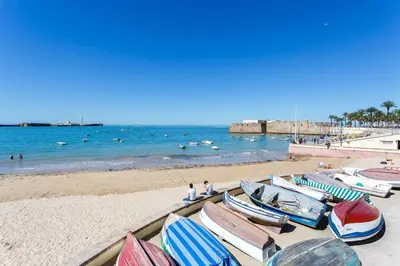 a group of boats sitting on the beach at Casa La Muralla MEDIEVAL by Cadiz4Rentals in Cádiz