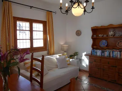 a living room with a white couch and a window at Apartamento Caracola in Chipiona