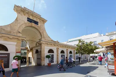 a group of people walking in front of a building at La Sorpresa del GENOVES by Cadiz4Rentals in Cádiz