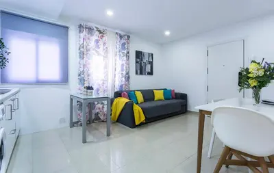 a living room with a couch and a table at El Balneario in Cádiz