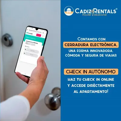 a person holding a cell phone in front of a door at SAIL Family Home by Cadiz4Rentals in Cádiz