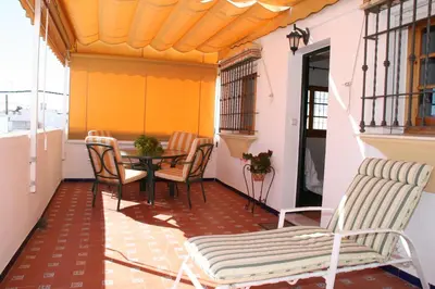 a balcony with a table and chairs on it at Apartamento Playa de Regla, Aire acondicionado, Garaje in Chipiona