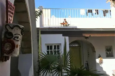 a dog sitting on the balcony of a building at Casa Florinda #1 in Jerez de la Frontera