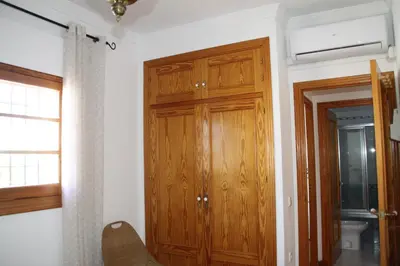 a room with a wooden closet and a door at Penthouse on the Costa de la Luz, Air conditioning, beach 300 meters away in Chipiona
